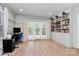 Bright living room with built-in bookshelves, French doors, and a desk area at 1024 Regency Dr, Charlotte, NC 28211