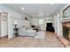 Cozy living room with a brick fireplace, neutral-toned furniture, and decorative molding at 1024 Regency Dr, Charlotte, NC 28211