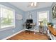 Home office with two large windows, a modern desk, and hardwood floors at 1024 Regency Dr, Charlotte, NC 28211