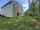 View of a spacious backyard and patio, perfect for outdoor relaxation and entertainment near a wood line at 1070 Glenbriar Ct, Woodleaf, NC 27054