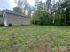 A large backyard offers plenty of space for recreation, backing onto a lush tree line at 1070 Glenbriar Ct, Woodleaf, NC 27054