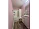 Stylish bathroom with light-purple walls, a shower and tub, a single sink vanity with granite countertops, and grey mats at 1070 Glenbriar Ct, Woodleaf, NC 27054