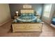 Beautiful bedroom with a king-sized bed, decorative pillows, matching nightstands and lamps, and carpeted floors at 1070 Glenbriar Ct, Woodleaf, NC 27054