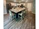 Well-appointed kitchen with ample seating, stainless steel appliances, and generous countertop space at 1070 Glenbriar Ct, Woodleaf, NC 27054