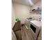 Practical laundry room with modern washer and dryer, shelving, and a convenient folding counter at 1070 Glenbriar Ct, Woodleaf, NC 27054