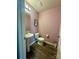 Compact half-bathroom offering convenience with a pedestal sink and classic fixtures at 1070 Glenbriar Ct, Woodleaf, NC 27054