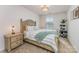 Comfortable bedroom with neutral colors, patterned bedding, and natural light from the window at 11062 Discovery Nw Dr, Concord, NC 28027