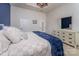 Comfortable bedroom with large dresser, a blue accent wall and neutral color scheme throughout at 11062 Discovery Nw Dr, Concord, NC 28027