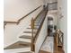 Welcoming foyer featuring hardwood floors, decorative staircase with a long runner, and a console table at 11062 Discovery Nw Dr, Concord, NC 28027