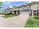 Exterior view of townhome featuring front entry two-car garage at 11062 Discovery Nw Dr, Concord, NC 28027