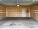 Spacious two car garage with a service door and lighting at 11062 Discovery Nw Dr, Concord, NC 28027