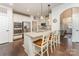 Bright, modern kitchen with granite countertops, stainless appliances, and a cozy breakfast bar seating three at 11062 Discovery Nw Dr, Concord, NC 28027