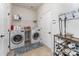 Functional laundry room equipped with a washer, dryer, shelving, and space for storage solutions at 11062 Discovery Nw Dr, Concord, NC 28027