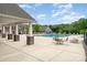 Community pool with lounge chairs, picnic tables and shade at 11062 Discovery Nw Dr, Concord, NC 28027