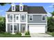 Charming two-story home featuring a covered front porch, two-car garage, and dormer windows at 115 Canary Ln # 19, Mooresville, NC 28115