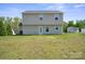 View of the home's rear exterior featuring a two-story design and spacious backyard at 118 Maplecrest Dr, Kings Mountain, NC 28086
