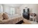 Bright bedroom features neutral walls, TV on dresser, and a comfortable bed with stylish comforter at 118 Maplecrest Dr, Kings Mountain, NC 28086