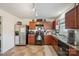 The kitchen features dark wood cabinetry, stainless steel appliances, and tile flooring at 118 Maplecrest Dr, Kings Mountain, NC 28086