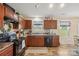 A kitchen with dark wood cabinets, modern appliances, and neutral countertops at 118 Maplecrest Dr, Kings Mountain, NC 28086