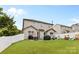 Large, fenced backyard featuring a patio with furniture, a grill, green grass, and play structures at 12604 Congregation Dr, Charlotte, NC 28278