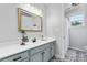 Bathroom with stylish black and white patterned tile floor, a shower, and modern sink at 12604 Congregation Dr, Charlotte, NC 28278