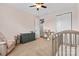 Cozy Bedroom with carpet, ceiling fan, changing table, and storage for all the baby's needs at 12604 Congregation Dr, Charlotte, NC 28278