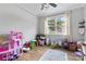 Bright bedroom offers wood flooring, a ceiling fan, natural light, and ample space for play at 12604 Congregation Dr, Charlotte, NC 28278