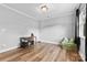 Hardwood-floored bonus room with a desk, chair, and soft seating area for comfort at 12604 Congregation Dr, Charlotte, NC 28278
