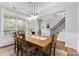 Elegant dining area with natural light, a stylish chandelier, and hardwood floors at 12604 Congregation Dr, Charlotte, NC 28278