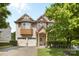 Charming two-story home featuring stone accents, well-manicured lawn, and attached two-car garage at 12604 Congregation Dr, Charlotte, NC 28278