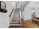 Welcoming foyer with a staircase, hardwood floors and views of the adjacent living spaces at 12604 Congregation Dr, Charlotte, NC 28278