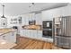 Bright kitchen featuring stainless steel appliances, light wood floors and ample white cabinets at 12604 Congregation Dr, Charlotte, NC 28278