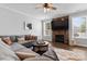 Comfortable living room with stone fireplace, lots of light and a neutral color palette at 12604 Congregation Dr, Charlotte, NC 28278