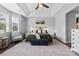 Bright and airy main bedroom features a ceiling fan, a bed with nightstands, and lots of natural light at 12604 Congregation Dr, Charlotte, NC 28278