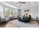 Bright and airy main bedroom features a ceiling fan, a bed with nightstands, and lots of natural light at 12604 Congregation Dr, Charlotte, NC 28278