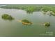 Panoramic aerial view of a lake with lush green islands and surrounding wooded areas at 131 High Lake Dr, Statesville, NC 28677