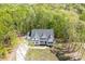 A bird's-eye view of a charming white home with dark shutters surrounded by mature trees at 131 High Lake Dr, Statesville, NC 28677