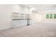 Spacious basement featuring a functional kitchenette, carpeted floor, and natural light at 131 High Lake Dr, Statesville, NC 28677