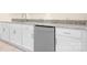 Basement kitchenette boasts granite counters, stainless steel dishwasher and modern cabinetry at 131 High Lake Dr, Statesville, NC 28677