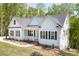 Charming white farmhouse with black shutters, a covered porch, and landscaped front yard at 131 High Lake Dr, Statesville, NC 28677