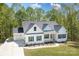 Aerial view of a pristine white house with a manicured lawn and lush greenery at 131 High Lake Dr, Statesville, NC 28677