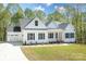 Charming white home with black shutters, well-manicured lawn, and attached two-car garage at 131 High Lake Dr, Statesville, NC 28677