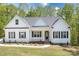 Attractive home featuring black shutters, a charming front porch, and manicured landscaping at 131 High Lake Dr, Statesville, NC 28677