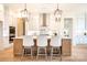 Stylish kitchen featuring a large island with seating, white cabinets, and stainless steel range hood at 131 High Lake Dr, Statesville, NC 28677