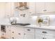 This modern kitchen features white cabinets, stainless steel appliances, and stylish backsplash at 131 High Lake Dr, Statesville, NC 28677