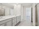 Modern bathroom features a double sink vanity, a large mirror and a glass-enclosed shower at 139 Satchel Ct, Mooresville, NC 28115