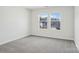 Bedroom featuring gray carpet and light walls with a large window overlooking the neighborhood at 139 Satchel Ct, Mooresville, NC 28115