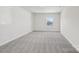 Spacious carpeted bedroom with a large window offering ample natural light at 139 Satchel Ct, Mooresville, NC 28115