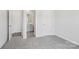 Carpeted bedroom with an ensuite bathroom and walk-in closet visible through open doors at 139 Satchel Ct, Mooresville, NC 28115