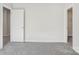 Bright bedroom with gray carpet and light walls and two entry doors to closets at 139 Satchel Ct, Mooresville, NC 28115